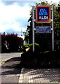 ST6390 : Aldi name sign and opening hours, Quaker Lane, Thornbury by Jaggery