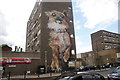 View of a dog mural on the side of a block of flats on Chrisp Street