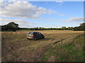 TF7123 : Car in a stubble field, Congham by Jonathan Thacker