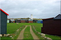 SY6868 : Old Lower Lighthouse and holiday huts by Robin Webster