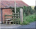 Stile by pavement on footpath