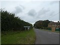 Village sign on road through West Knighton