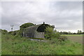 Derelict structure of corrugated asbestos cement