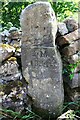 Stone post with initials and date on south side of rural road west of Little Stainton