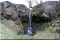 NY8779 : Waterfall at Holy Well by Andrew Curtis