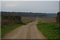 TM5283 : Suffolk Coast Path running inland along the drive to Beach Farm by Christopher Hilton