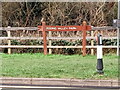 View of the wooden Roding Valley Park entrance sign on Roding Lane South