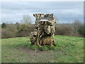 A stump that has figures and a view