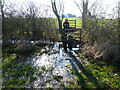 Flooded stile crossing in February