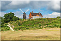 TQ2350 : Reigate Heath Windmill and Reigate Heath Golf Club clubhouse  by Ian Capper