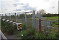 Railway access gate to east side of track from north side of road