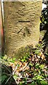 Benchmark on gatepost at field gateway on north side of road west of Crosshill