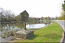 TF8037 : Stanhoe village sign and pond by Adrian S Pye