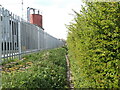 A narrow path beside the industrial units