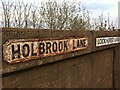 Signs on railway bridge where Holbrook Lane and Lockhurst Lane meet