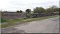 NY3767 : Field gate and wall (parapet of Fauld Mill Bridge) on east side of Arthuret Road by Roger Templeman