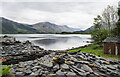 Shore of Loch Leven with stacked slate waste