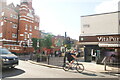 View of street art on the side of the parade of shops on Globe Road from Roman Road