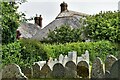 Burrington, Holy Trinity Church: Thatched cottage seen from the churchyard