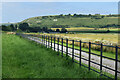 ST9928 : Roadside fence with view of Fovant Badges by David Martin