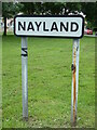 TL9634 : Nayland Village Name sign by Geographer