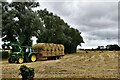 TQ9928 : Snargate: Collecting baled straw from a recently harvested field by Michael Garlick