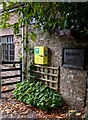 Yellow box on the wall of the village hall, Tregare, Monmouthshire