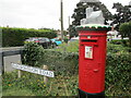 TM5076 : Knitted  top  on  letterbox  at  road  junction by Martin Dawes