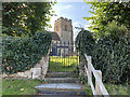 The church of St Michael and All Angels seen from White Hart Lane, Ufton