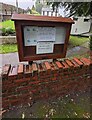 Information board above a low brick wall, Glascoed, Monmouthshire