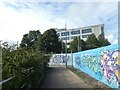 Graffiti on hoardings by riverfront path, Newport