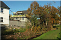 Stream and new houses, Longston Cross