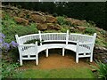 Curved bench in a rock garden