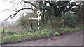 Broken direction sign beside Wheatham Lane