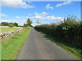 NT5328 : Hedge and wall enclosed minor road between Midlem and Eastfield by Peter Wood