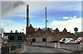 Looking into waste processing depot from security gate