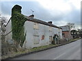 Abandoned derelict farm house beside the road