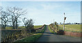 Green fields on either side of the road