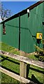 Yellow box on a green wall, Harescombe, Gloucestershire