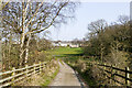 Fenced path descending from bridge over motorway