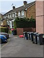 Dark green bins outside Almond Court, Malpas, Newport