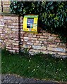 Yellow box on a Church Lane wall, Whaddon, Gloucestershire