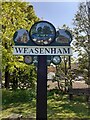TF8522 : Weasenham village sign re-painted by Jane Rackham