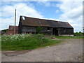 Old wooden corrugated tin-roofed barn at Hall Farm, Sidbury