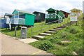 View of colourful beach huts on the coastal path at Tankerton