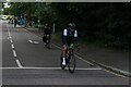 View of cyclists in the RideLondon event turning the corner from Broadmead Road into High Road Woodford Green #8