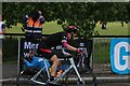 View of a cyclist in the RideLondon event turning the corner from Broadmead Road into High Road Woodford Green #2