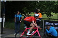 View of a cyclist in the RideLondon event turning the corner from Broadmead Road into High Road Woodford Green #11