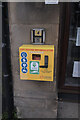 SJ4166 : Defibrillator on the shopfront by Bob Harvey