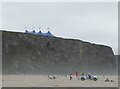 SW8364 : Watergate Bay - Cliffs, lifeguard and marquee by Rob Farrow
